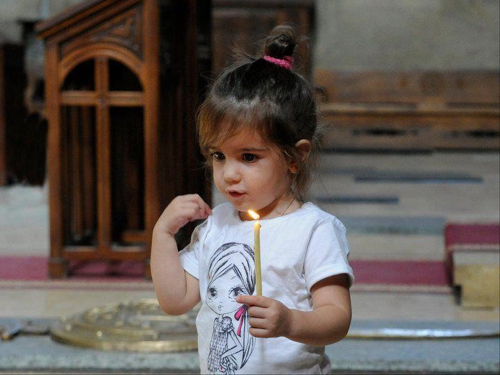 girl making the sign of the cross